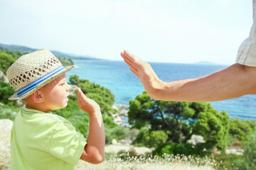 A hands of happy parents and children at sea in travel background in greece