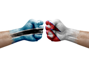 Two hands punch to each others on white background. Country flags painted fists, conflict crisis concept between botswana and nepal