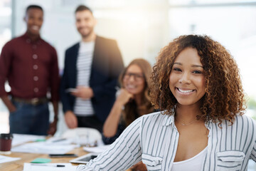 When you have a great team, you cant help smiling. Shot of creative employees working in a modern office.