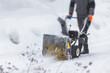 Process of removing snow with portable blower machine, worker dressed in overall workwear with gas snow blower removal on the street during winter
