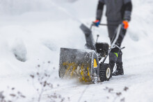 Process Of Removing Snow With Portable Blower Machine, Worker Dressed In Overall Workwear With Gas Snow Blower Removal On The Street During Winter
