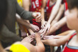 © tsuguliev - Team of kids children basketball players stacking hands in the court, sports team together holding hands getting ready for the game, playing indoor basketball, team talk with coach, close up of hands