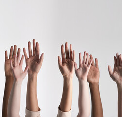 Poster - Making their voices heard. Shot of a diverse group of unidentifiable people holding their hands up against a white background.