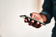 © Chanelle Malambo/peopleimages.com - Staying connected in this digital age. Cropped shot of an unrecognizable businessman standing alone in his home office and texting on his cellphone.