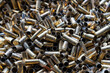 © OlegD - Bunch of empty pistol shells as a background. Pile of used pistol cartridges.