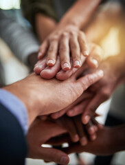 Leinwandbilder - When were all in, we all win. Cropped shot of a group of businesspeople joining their hands in solidarity.