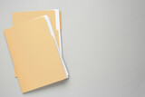 Fototapeta  - Yellow files with documents on light grey background, top view. Space for text