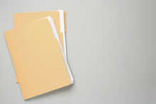 Yellow Files With Documents On Light Grey Background, Top View. Space For Text