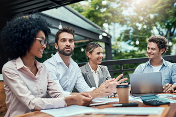 Productive meetings beyond the boardroom. Shot of a group of colleagues having a meeting at a cafe.