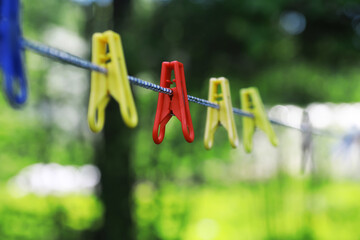 Wall Mural - Clothespins on a clothesline in summer. Dry clothes outside. Clothes on a rope.