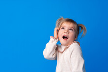 Funny Portrait Of A Cute Little Blonde Girl Pretend Talking On The Phone