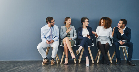 Aufkleber - Friendly conversation calms the pre-interview nerves. Studio shot of a group of businesspeople talking while waiting in line against a gray background.