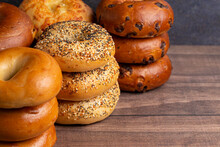 Variety Of Different Flavored Bagels On A Wood Table