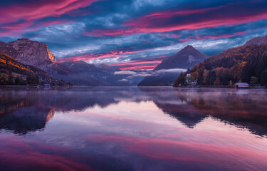Fototapete - Sunrise view on Alps above Grundlsee lake. Colorful cloudy sunset over the hills with Alpine lake. Amazing nature scenery with reflection in the calm water. Grundlsee. Austria. Europe