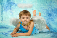 Boy Dressed As An Angel, Blue Background