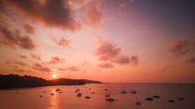 Marinas In The Bay Have Many Sailboats At Sea With Beautiful Sunrise Tropics In Phuket, Thailand.