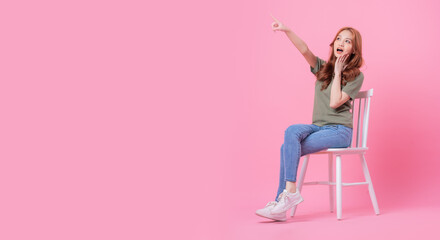 Wall Mural - Young Asian woman posing on pink background