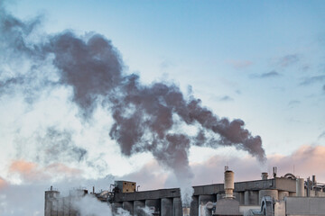 Industrial district and smoke polluting the air. Lithuania Europe. day time at winter season.