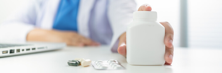 Professional medical doctor hand giving medicine. protect against coronavirus COVID-19 medicine healthcare concept doctor giving pills to patient