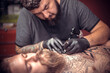 © Mr. Prof - Tattoo specialist making tattoo art in salon