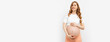 Pregnant happy woman touches her belly. Pregnant mom caressing her belly and smiling close up. Healthy pregnancy concept
