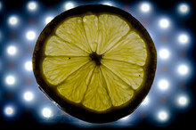 Close-up View Of A Lemon Slice Backlit By Led Lights To Show The Texture Of The Pulp With Its Designs