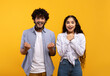 © Prostock-studio - Wow, yes. Portrait of overjoyed indian man and woman cheering and shaking clenched fists looking at camera in excitement