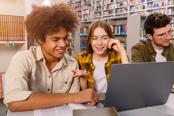 Wall Mural - University students are studying in a library together as teamwork for preparation