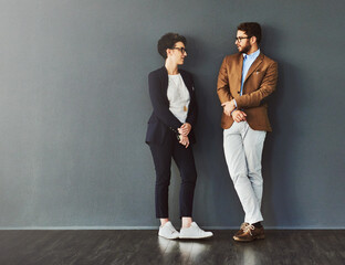 Aufkleber - You can learn a lot from your colleagues. Shot of two designers having a conversation while leaning against a wall.