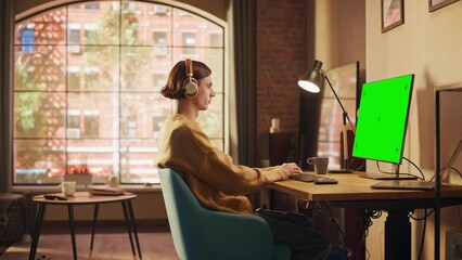 Poster - young handsome man working from home on desktop computer with green screen mock up display. creative