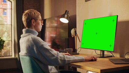 Poster - Young Beautiful Female Working from Home on Desktop Computer with Green Screen Mock Up Display. Creative Girl Checking Social Media, Browsing Internet. Urban City View from Big Window.