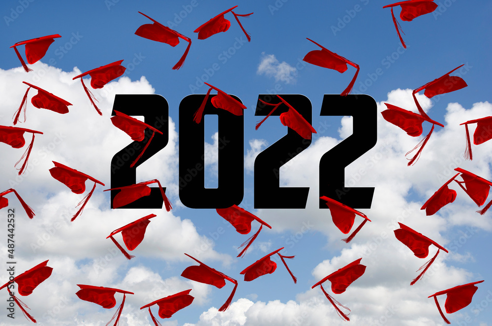 Airborne Graduation Cap Design Red graduation caps airborne in summer sky with 2022 text Stock Photo ...