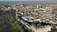 Aerial Footage Of The Town Centre Of Harrogate In The UK A Town In North Yorkshire, Showing Buildings And Businesses In The Town Centre Along With Roads And Paths And The Harrogate Train Station