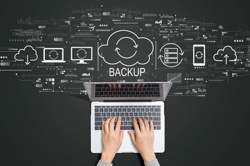 Backup concept with person using a laptop computer