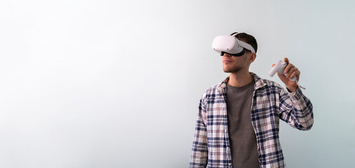 Wall Mural - young guy using virtual reality googles, new modern technology headset