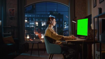 Poster - young handsome man working from home on desktop computer with green screen mock up display. creative