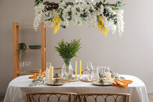 Stylish Table Setting With Beautiful Flowers In Dining Room