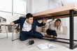 © New Africa - Scared employees hiding under office desk during earthquake