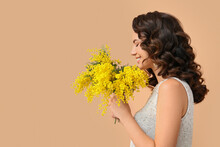 Beautiful Young Woman With Mimosa Flowers On Color Background
