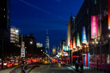 Fototapeta Nowy Jork - New York City night street scene at Chelsea Pier with blurred lights of the buildings and cars