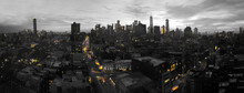Yellow Lights Of The New York City Skyline Shining Against A Black And White Cityscape In Manhattan NYC