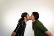 © Antonio Tanaka - portrait of a couple kissing very much in love on a white background