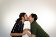 © Antonio Tanaka - portrait of a couple kissing very much in love on a white background