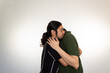 © Antonio Tanaka - portrait of a couple hugging very much in love on a white background