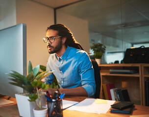 Fototapete - You need a tireless work ethnic to reach success. Cropped shot of a young designer working late on a computer in an office.