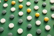 Many different pills on green background, closeup