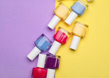 Set Of Nail Polish Bottles On Color Background