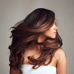 making hairstory everyday with gorgeous hair. studio shot of a young beautiful woman with long gorge