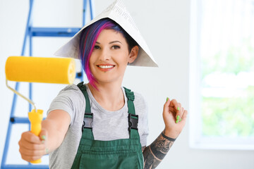 Sticker - Female painter with paper hat and roller in room