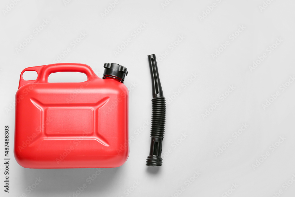 Plastic canister and rubber nozzle on light background